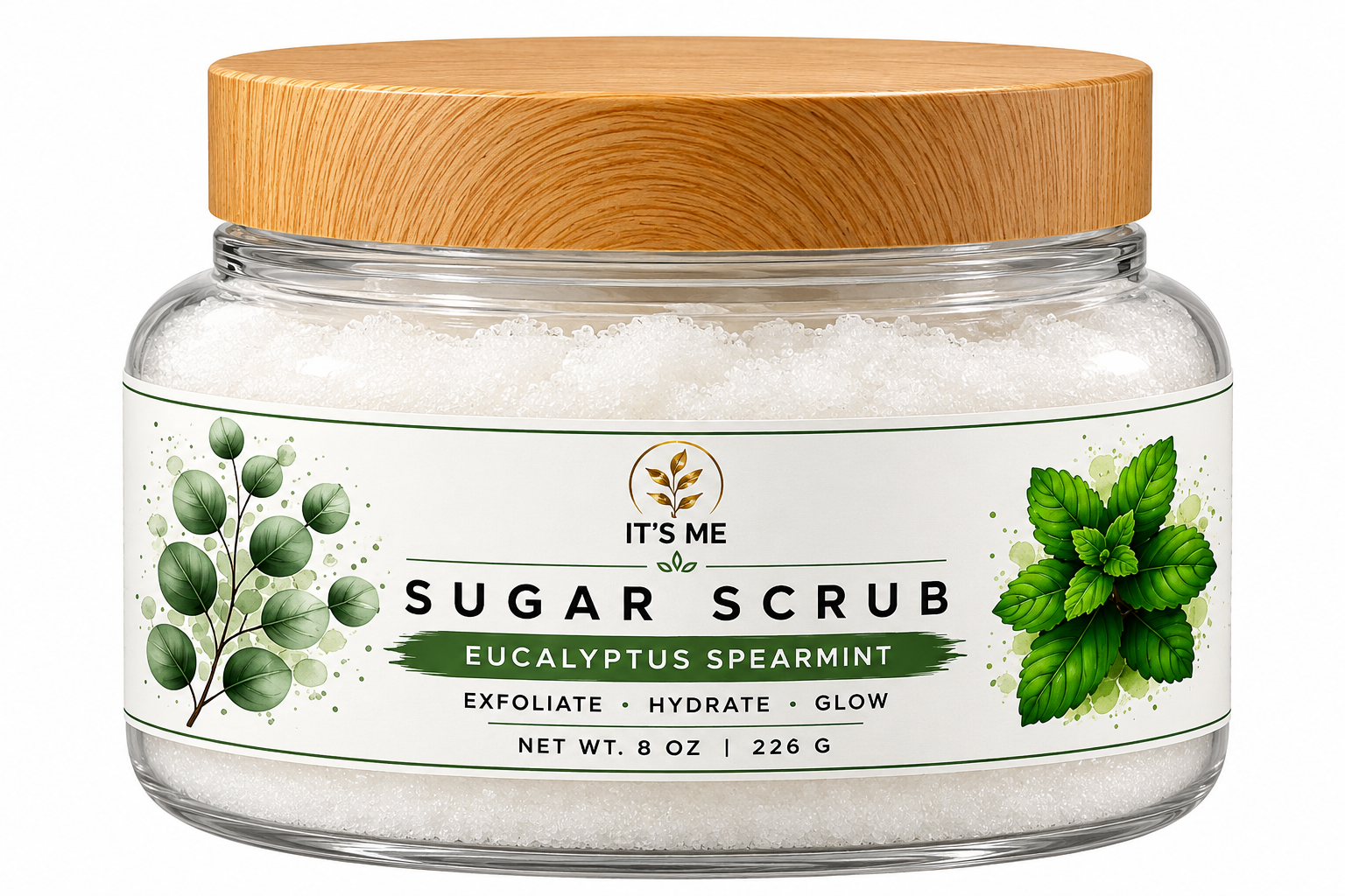 A jar of It's Me Sugar Scrub in Eucalyptus Spearmint scent, featuring white sugar exfoliate inside a clear glass jar with a light wood lid and a white label with green botanical illustrations.