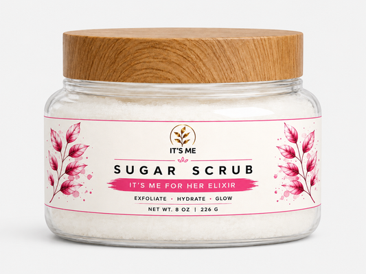 A jar of 'It's Me Sugar Scrub' with a light brown wooden lid and a white label featuring pink floral illustrations, set against a plain white background.